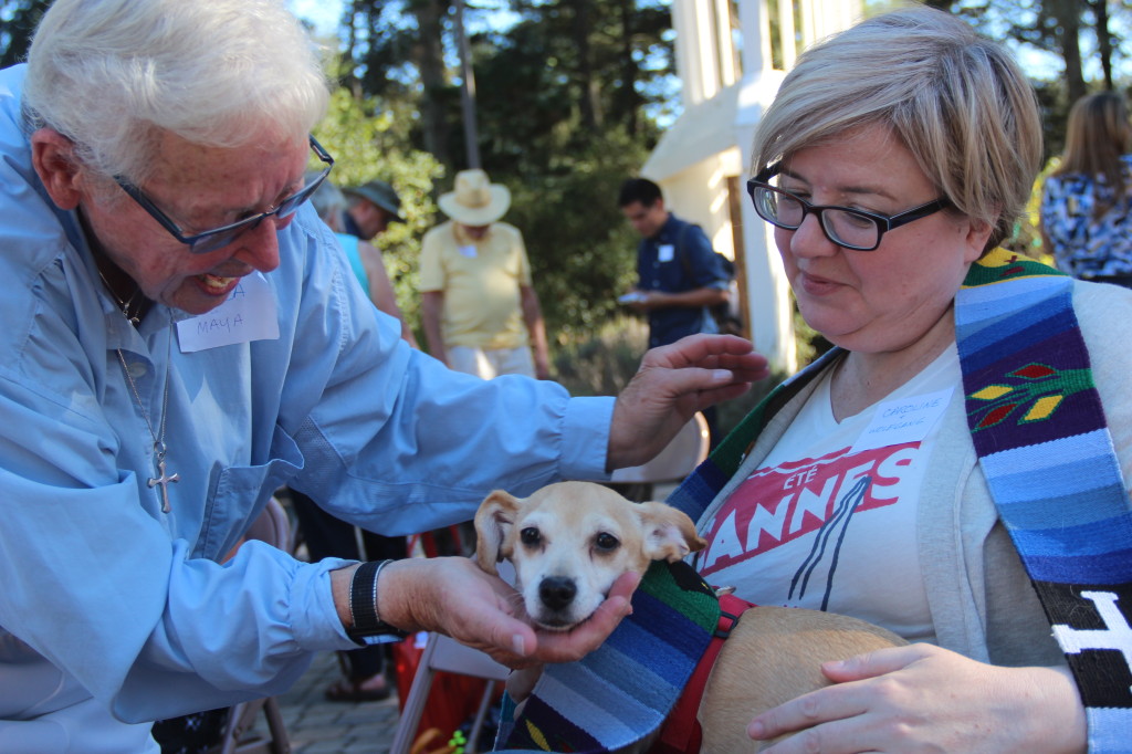 Rhea Babbitt blesses a dog and its owner. "I tell people that I found the dog," the owner said, "but really she found me." Photo by Sanosi Osman.