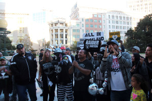 Members of Forever Oakland and Raiders fans gather in front of City Hall