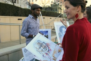 Oakland City Council member Libby Schaaf admires a painting by a local artist.