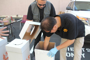 Paul Balzouman, inspector at the ACDA Office, helps Craig Chew, assistant chief of inspectors at the ACDA Office, place a bag of pharmaceutical drugs in the burn-up bin. Photo by Nicole A. West