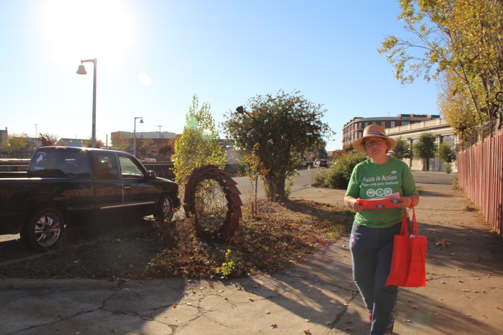 Paula Hawthorn walks down West MacArthur Boulevard on Election Day hoping to encourage voters to get to the polls.