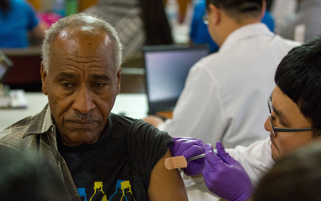 student pharmacist administers flu vaccine