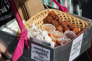 Kiana Tondre, 8 years old, prepares to take donut kebabs on the road for Mamacitas Cafe during Oakland's "Life is Living" festival.