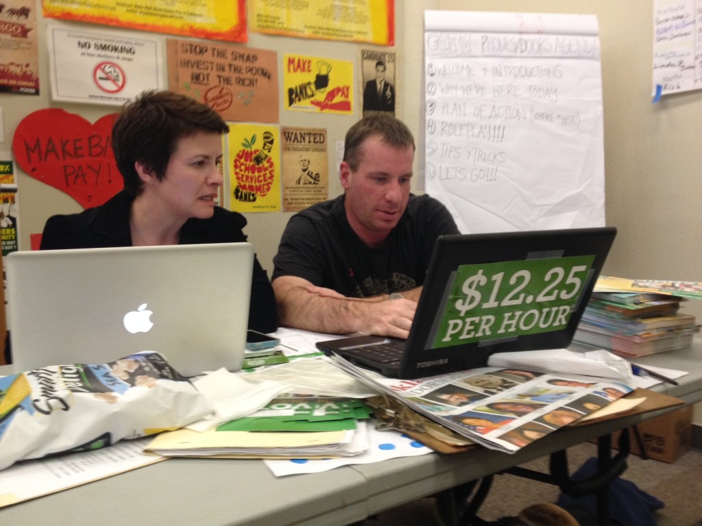 Volunteers at the Lift Up Oakland campaign headquarters work to support Measure FF to increase the minimum wage. Photo by Alex Kekauouhah.