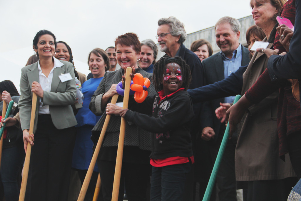 A Vincent Academy student tries her hand at shoveling at Thursday's groundbreaking ceremony.