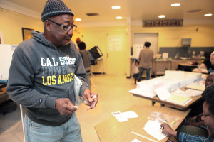 L.A. Ross, a security worker, casts his ballot at Martin Luther King Jr. Elementary School. Photo by Deana Mitchell.