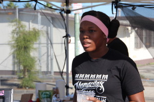 Iyonna Garcia, 14 years old, handles the cash register for Mamacitas Cafe at Oakland's "Life is Living" festival in October.