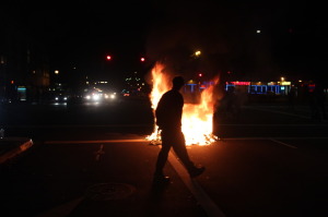 Some protesters started small fires, often setting fire to the contents of trash bins. Photo by Brett Murphy.