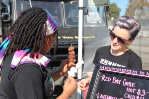 Shana Lancaster, co-founder of Mamacitas Cafe, provides a customer with fresh baked donut kebabs.