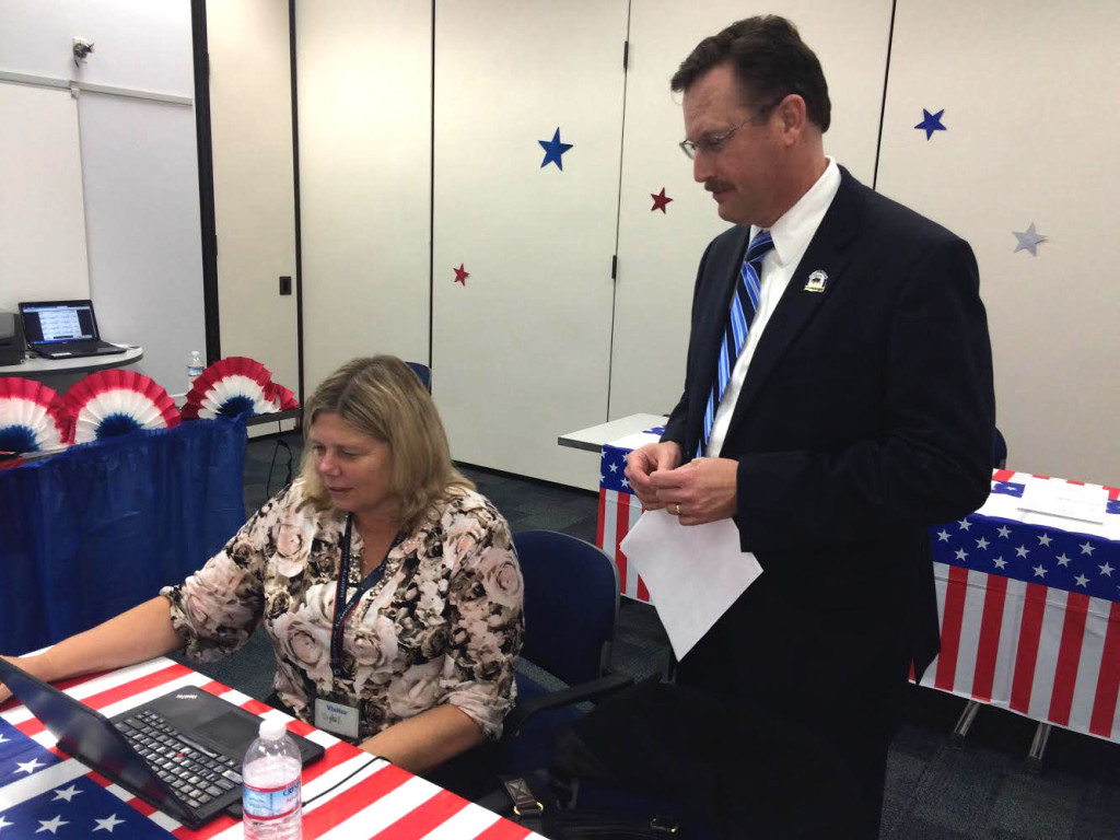 Registrar of Voters Tim Dupuis, reviews the ROV website for real-time numbers. Photo by Alicia Vargas.