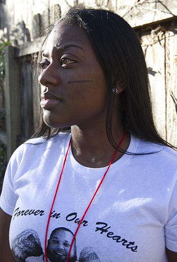 bria Shankle, 21, reflects after the tree planting ceremony. "The violence needs to stop," she said. Photo by Gina Pollack.