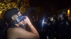 Some protesters got confrontational with the police, yelling, "You should be ashamed of yourself!" or "How do you sleep at night?" Photo by Alissa Greenberg.