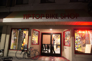 Employees at the TPeople at the Tip Top Bike Shop boarded up windows. Photo by Alyssa Jeong Perry.ip Top Bike Shop worked to board up broken windows. Photo by Alyssa Jeong Perry.