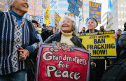 Fran Rachel, 97, a resident of Berkeley, dances at a rally calling for a fracking ban in California. Rachel's wooden handpainted sign dates back to Vietnam War protests; she is now a great-grandmother. (Photo by Bonnie Chan)