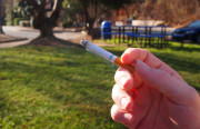 Woman holding cigarette. Photo source: "CIGARETTE" by Fried Dough on Flickr, shared via Creative Commons