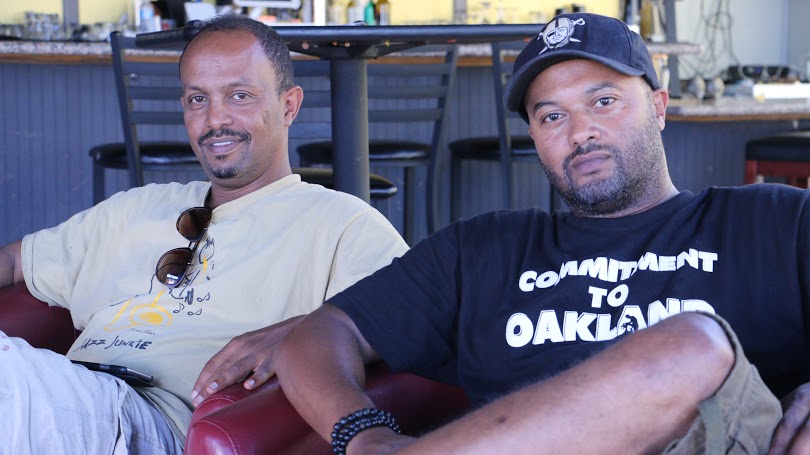 Teddy Shawl (left) and Mekdem Sebhatu(right), organizers of Saturday's Enkutatash concert in Oakland meet to discuss the event.