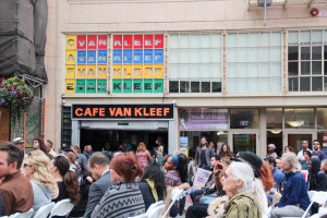 Loved ones of Peter Van Kleef gather in front of Cafe Van Kleef for his memorial service.