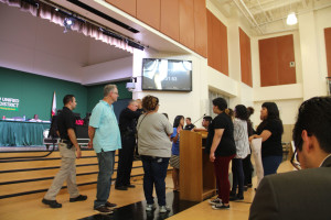 Yvette Felarca, of BAMN, speaks to members of the public after being escorted off-stage. Photo by Erika Alvero Koski.