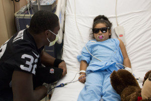 Keenan Lambert (left) visits with five-year-old Angelina Garavay, who was admitted recently after experiencing difficulty breathing.