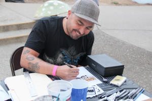 Marcos LaFarga draws a picture for auction.