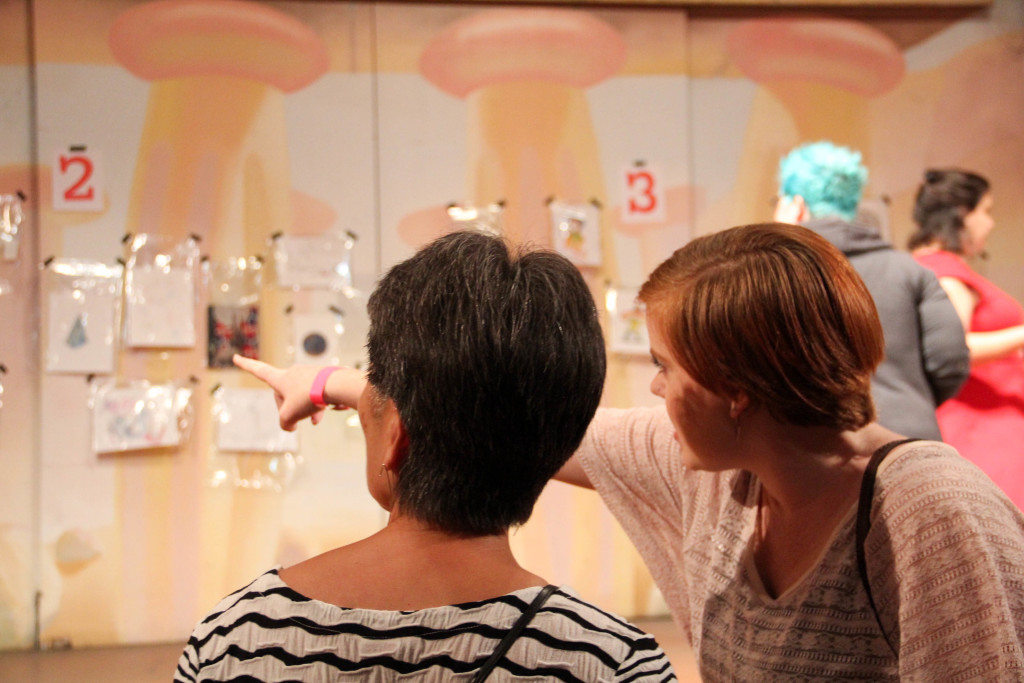 Attendees looking at the art on display in the Emerald City castle.