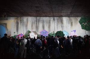 Mourners gathered under the 580 freeway on Wednesday morning to attend a candelight vigil for slain muralist Antonio Ramos. Ramos, a West Oakland-based artist employed by the nonprofit Attitudinal Healing Connection (AHC), was shot and killed Tuesday while working on a mural on West Street between 35th and 36th Streets.