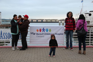 Juan Garcia (second from right), a patient at Children’s, waits to board with his mom (far right) and one of his sisters (center).