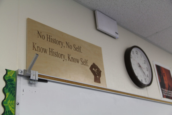 A sign reads "No History, No Self. Know History, Know Self."