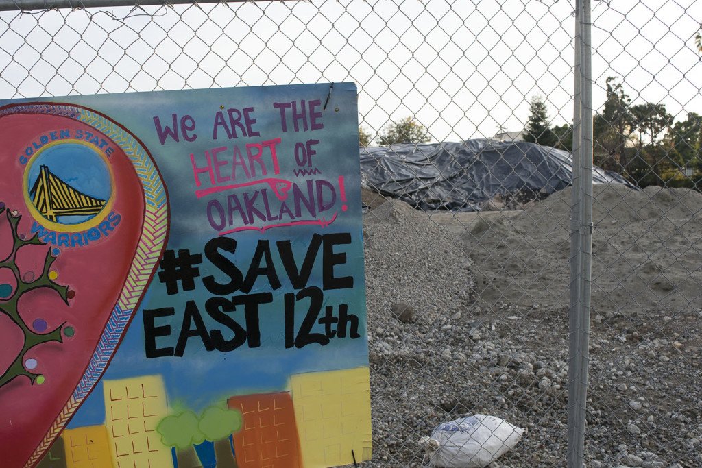 "We are the heart of Oakland!" is painted on the corner of a student art installation at the corner of East 12th Street and 1st Avenue in Oakland.