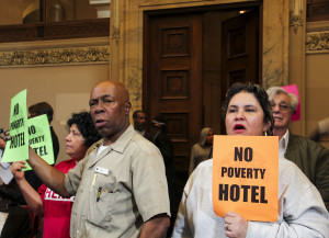 Activists and hotel workers holding up signs during Open Forum. Photo by Kyle Merrit Ludowitz
