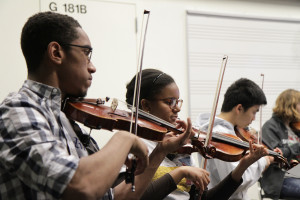 Violinists rehearse Beethoven's Symphony No. 5 in C Minor.