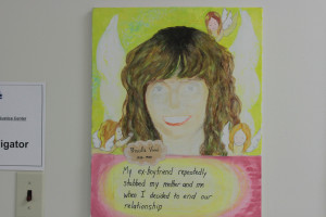 Paintings hang outside the DeafHope office memorializing women who were murdered.