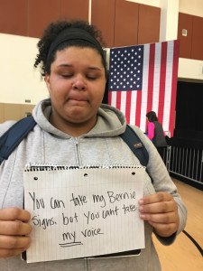 Kayla, 17, holds up a sign after Hillary Clinton's rally May 6 in Oakland. She is a n 11th grader at MetWest High School.