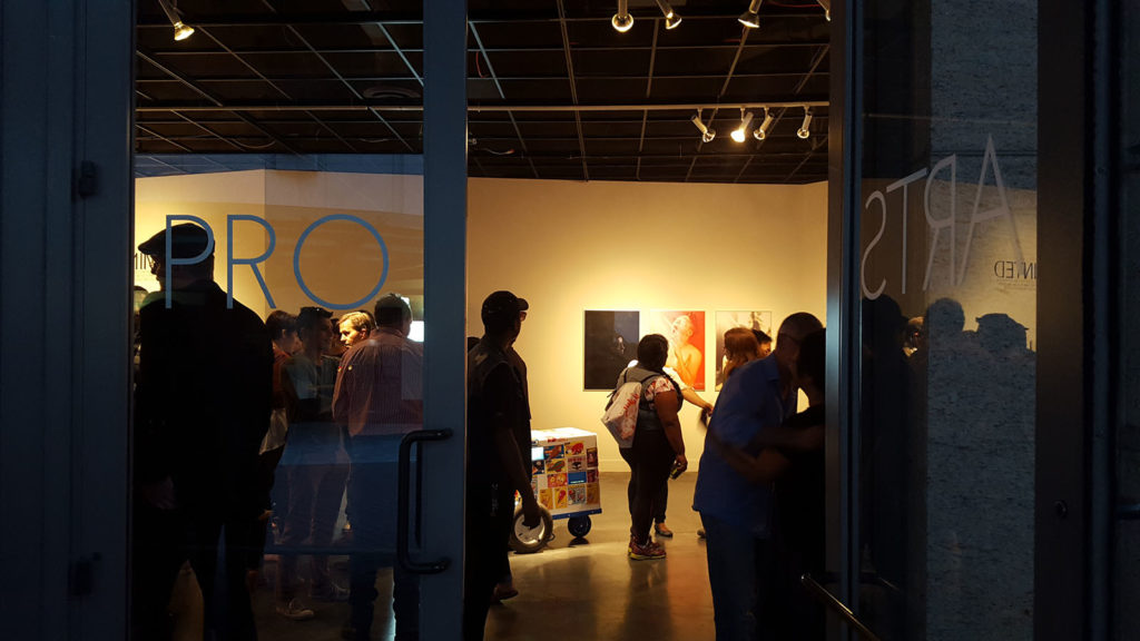 People mingle and check out the artwork at Friday’s opening of Minted exhibit at Pro Arts Gallery in downtown Oakland.
