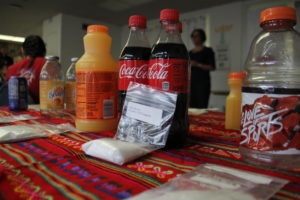 At the Oakland v. Big Soda campaign headquarters, a demonstration shows how much sugar is in each bottle of Coca-Cola.