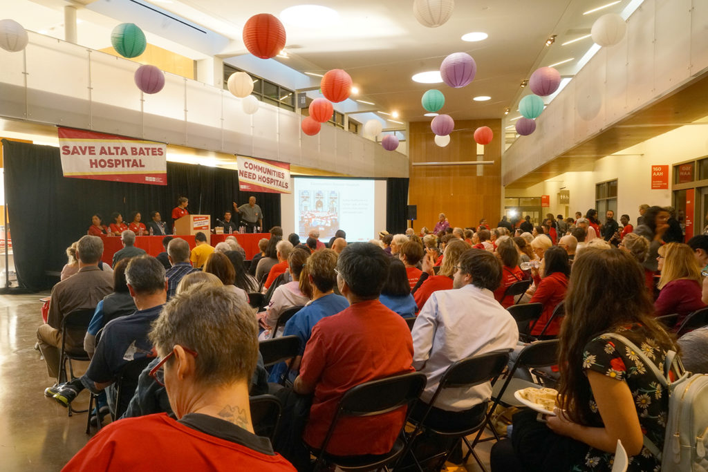 A crowd of CNA members, activists and legislators gather to discuss Sutter Health’s plan to close its Alta Bates Campus in Berkeley.
