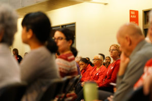 Three nurses, clad in CNA’s characteristic red, listened to the panel speakers from the audience.