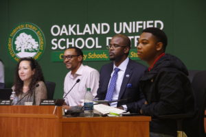 OUSD board members listen to speakers at this week's meeting. L-R: Vice President Nina Senn, President James Harris, Superintendent Antwan Wilson, and Student Director Darius Aikens. Photo by Cassady Rosenblum.
