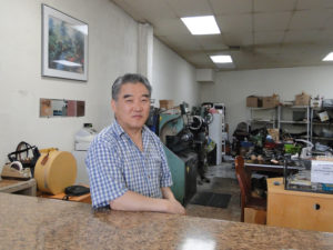 Jong Yun Lee inside his shoe repair shop on Telegraph Avenue and 46th Street