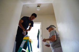 Eduardo Robles, Bay EMT, and American Red Cross volunteer work on a home, chaging an old smoke alarm in Fruitvale on Saturday, October 8, 2016. (Yesica Prado/Oakland North)