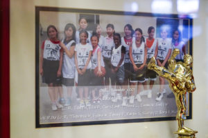 A sports trophy and a team picture sit in a glass case inside the Lincoln Park Recreation center at Lincoln Square Park on Thursday October 13, 2016. (Yesica Prado/Oakland North)