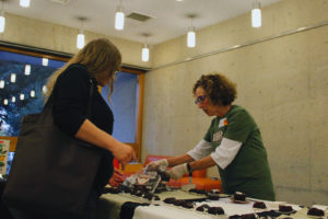 Staffer from Rubicon Bakers handing out food samples to visitors. Photo by Tian Chenwei