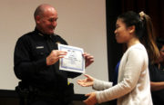 Oakland Police Department Assistant Chief David Downing awarded the graduation certificate to a graduate of Cantonese Language Citizen Police Academy. Photo by Tian Chenwei