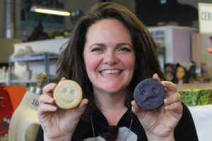 Jane Reyes, one of the event organizers, holds up her shortbread, chocolate and caramel cookies. The happy-faced cookie is filled with caramel, with chocolate ganache neatly surrounding the entire cookie; the sad-faced one has caramel and ganache together. “So it’s all mixed up,” Reyes said, wordplay intended.