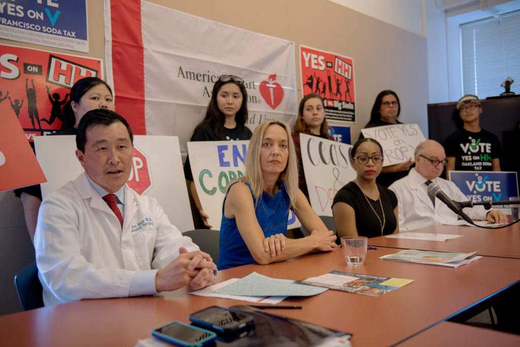 From left, Dr. John Maa, secretary of the San Francisco Medical Society; Annie Campbell Washington, Oakland vice mayor; San Francisco Board of Supervisor member Malia Cohen; and Dr. Jared Fine, the former dental health administrator for the Alameda County Public Health Department, host a press conference Friday afternoon at the Oakland headquarters of the American Heart Association after U.S. Sen. Bernie Sanders sent a cease and desist letter to the opposition of Measure HH. Photo by Rosa Furneaux.