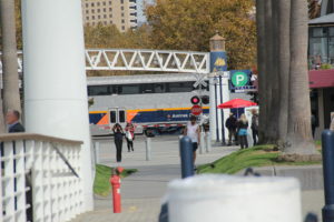 The AMTRAK train passes by honking its horn to let everyone know its coming.