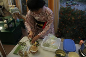 Japanese green tea was prepared and served in the showcase of a traditional Japanese tea ceremony. The hostess served four students who recently spent two weeks in Japan for a student exchange program.