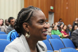 Director Jumoke Hinton Hodge of District 3 reacts to Nicole Funes, Castlemont Student Body President, recounting how she has thrived at Castlemont.