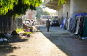 A homeless man walks towards a tent in a encampment behind the Chinese Garden Park in Oakland on Saturday, October 1, 2016. (Yesica Prado/Oakland North)