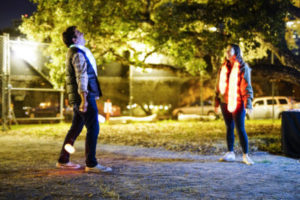 Volunteers laugh as they enjoy playing with neon light balls at the Autumn Lights Festival in Oakland on Wednesday, October 12, 2016. (Yesica Prado/Oakland North)